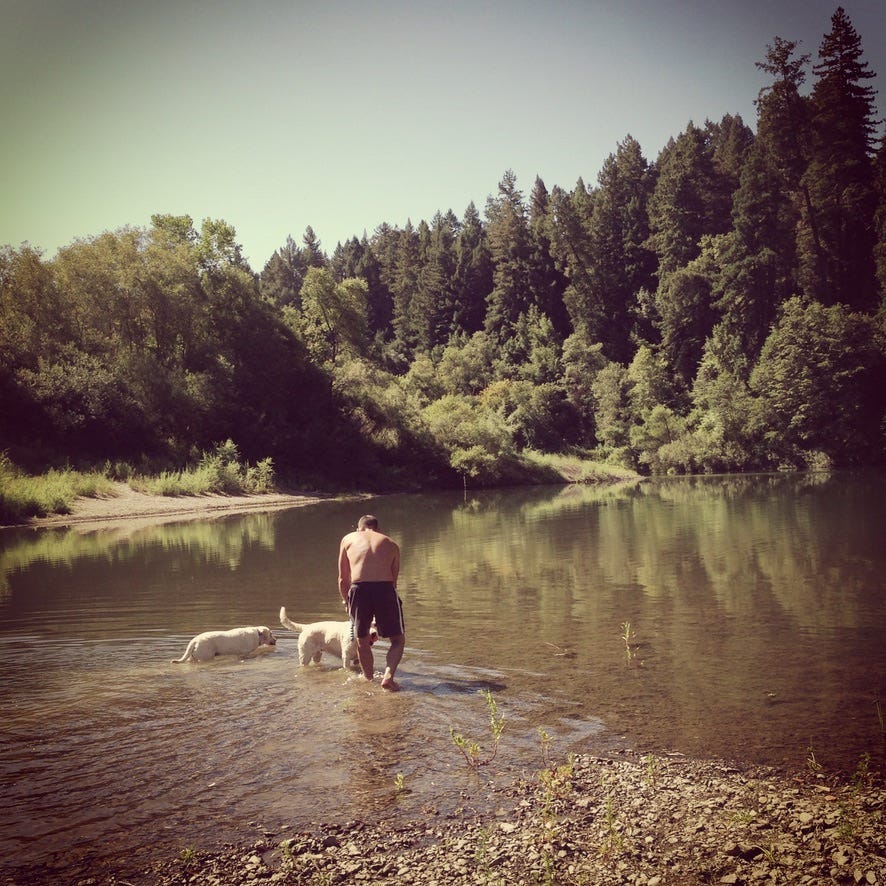 My older brother Spencer the summer before he died playing with his dogs Angel and Bella