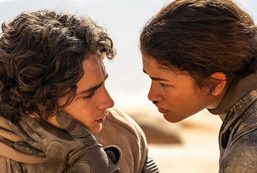 A woman (R) gazes reassuringly into a man’s eyes. Dune: Part Two