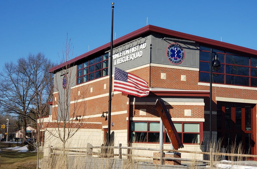 An American flag flies at half-staff outside of the Princeton First Aid & Rescue Squad Building, in memory of the 500,000 Americans who have died since the start of the COVID-19 pandemic.