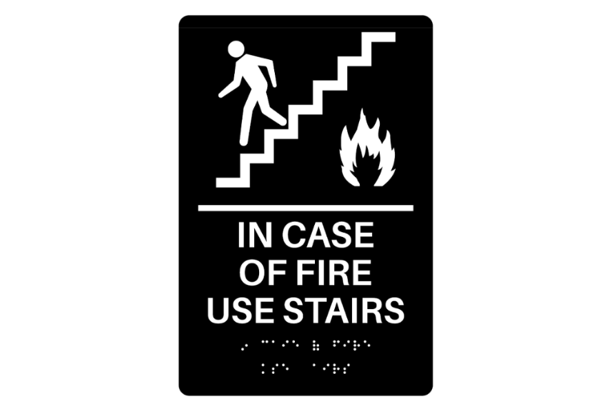 A sign that says “in case of fire use stairs”.