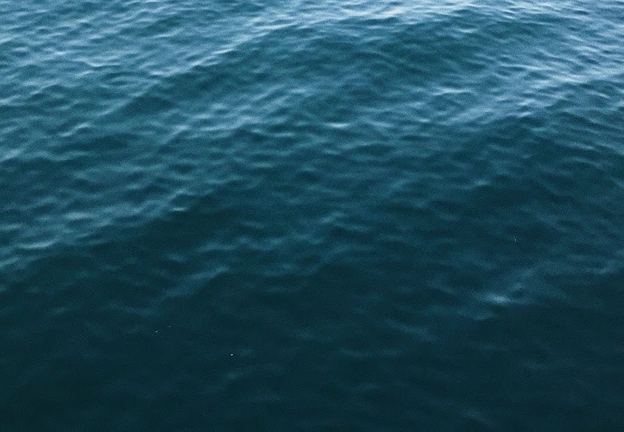 detailed ripples on the surface of the sea in Brighton. It fades from light at the top to a deep darkness at the bottom.
