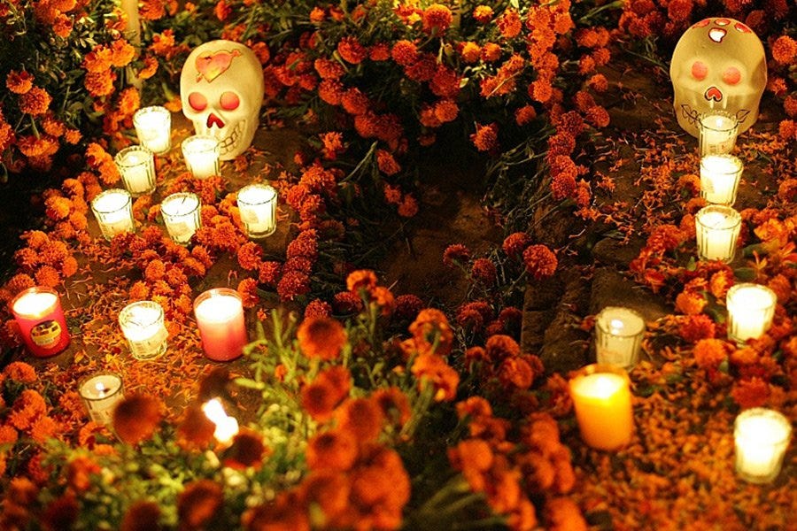 Skulls, candles, and marigolds adorn graves.