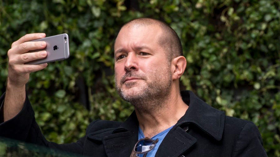 Jony Ive holding an iPhone