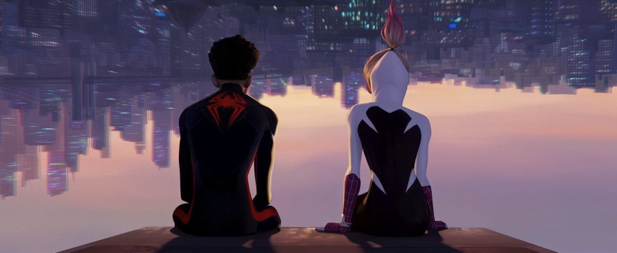 frame from Across the Spider-Verse. Gwen and Miles are sitting side-by-side, overlooking Brooklyn from a clocktower upside down. The sky is washed with pinks and purples and the city is lit up in the dusk