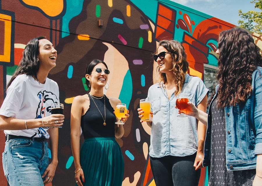 4 women talking and drinking