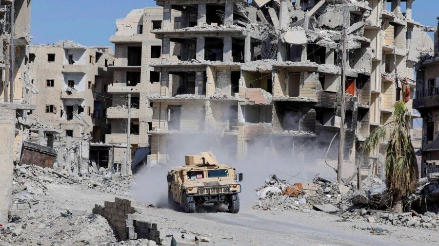 An armoured vehicle of the Syrian Democratic Forces is seen along a road at the frontline in Raqqa, Syria, October 8, 2017. Photo by Erik De Castro/Reuters