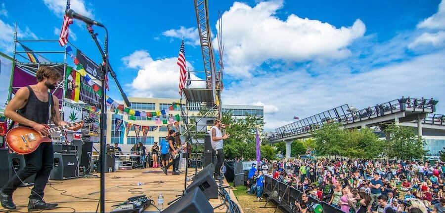 A band performing on stage in front of an audience at Seattle Hempfest. Image via Seattle Hempfest.
