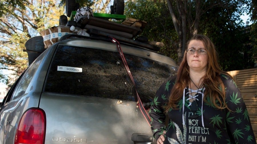 “Jocelyn,” an Army veteran, stands by the car she uses as her home in Venice, California, January 2022, Photo by Diane Baldwin/RAND Corporation