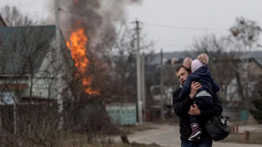 Residents flee from the town of Irpin, Ukraine, after heavy shelling by Russia destroyed the only escape route used by locals, March 6, 2022. Photo by Elizabeth Frantz/Reuters