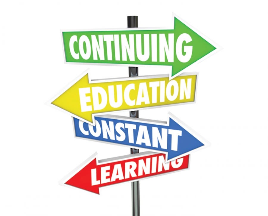 Multi colored road signs that say “Continuing Education Constant Learning”