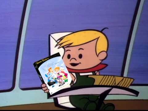 Elroy Jetson reading a paperback book.