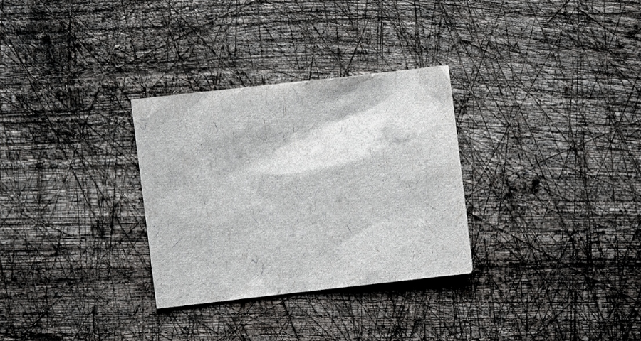 A blank piece of paper on a wooden surface