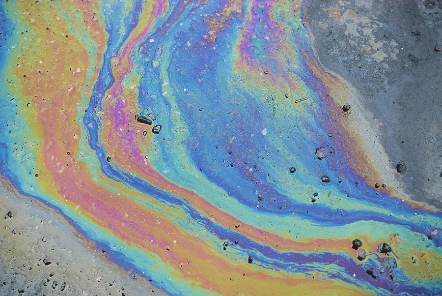 Photograph of an oil slick, by msrphoto via Unsplash