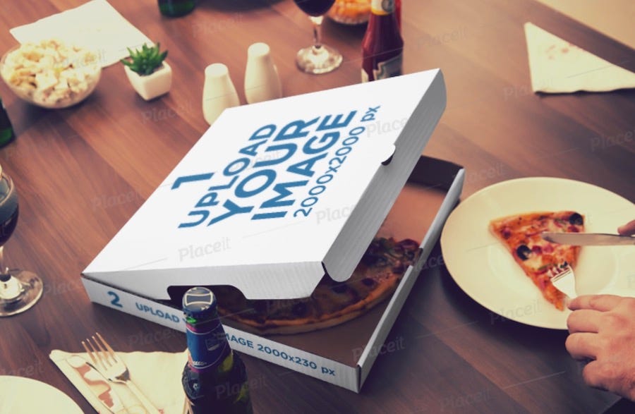 mockup of an open pizza box placed next to a person cutting a slice