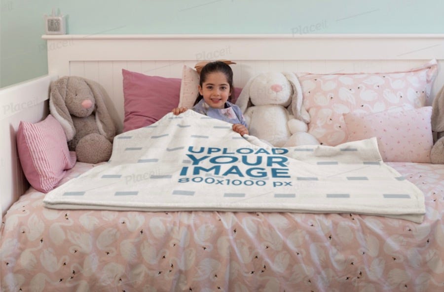 mockup of a happy little girl lying under a woven blanket