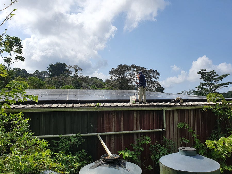 Photo: Maintaining solar panels with rain water catchment