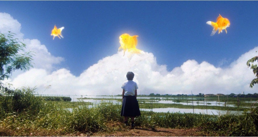 A high school girl in uniform looking out toward a surreal landscape composed of a vast lake below and above it a bright blue sky with thick white clouds. Among the clouds are three gold fishes swimming in the air, their bodies glowing against the sunshine.