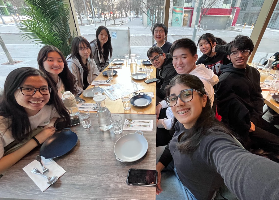 A group selfie of the 1UP Creatives Team after the 1UP Conference at a restaurant table.
