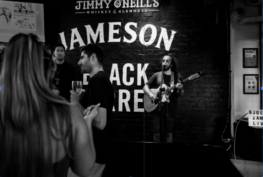 Joel plays guitar in a pub where the audience ignores him