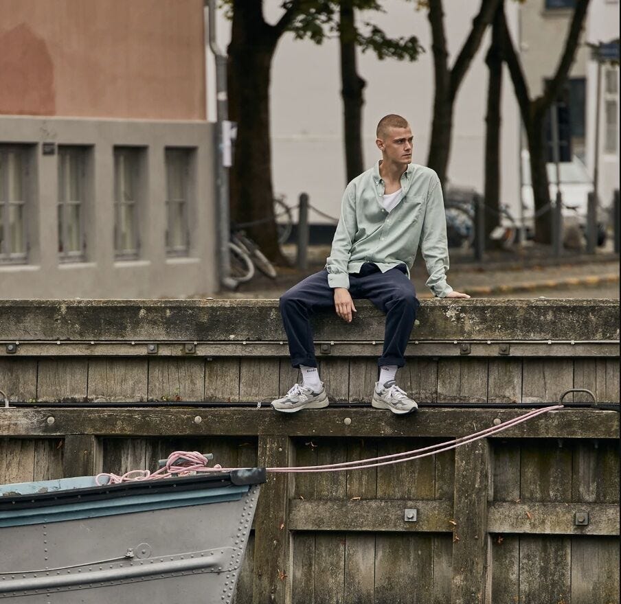 Man sitting on the side of dock