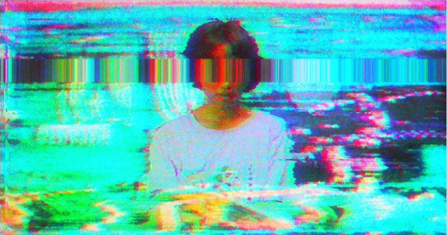 A 14-year-old girl seated in front of a strange dinner spread. The image is distorted as if coming from a broken television. Various artifacts and layers of noise envelop her—a large blurry line of tape noise extends across the screen covering her eyes as if it were a blindfold.