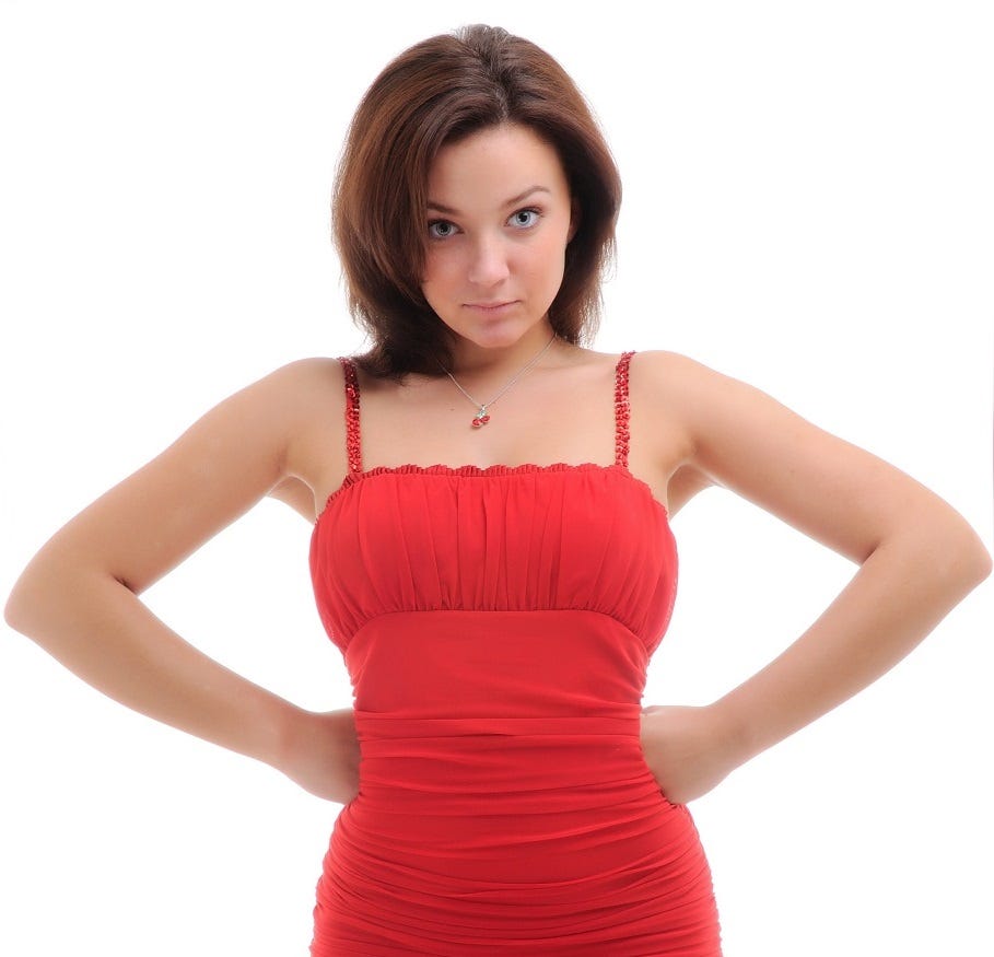 A woman in a red dress puts her hands on her hips.
