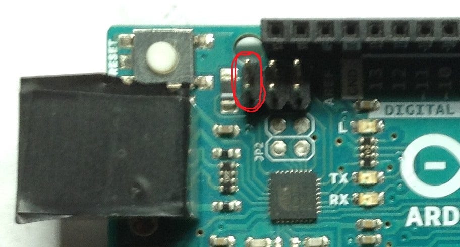 Circled in red: two pins closest to the USB input end of the board on the 6 pin pad.