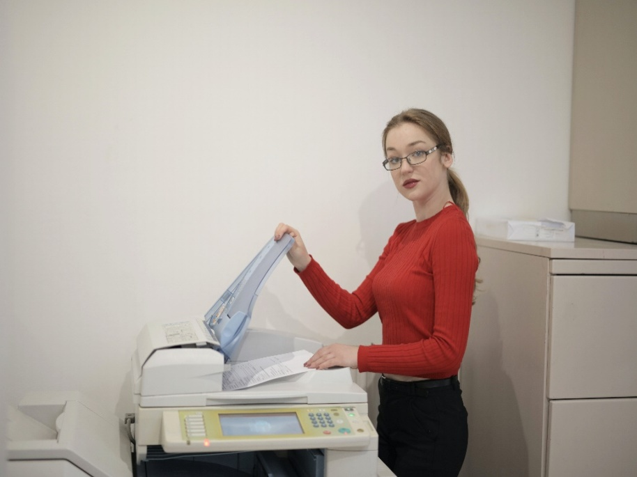A woman using a copier machine