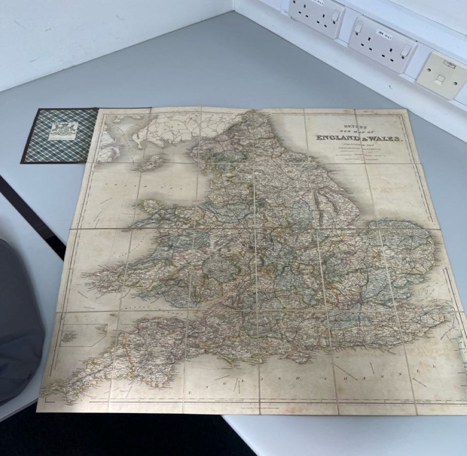 A map of England and Wales displayed on a desk