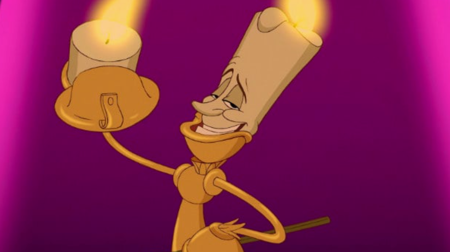 Lumière, the candle, smiling widely.