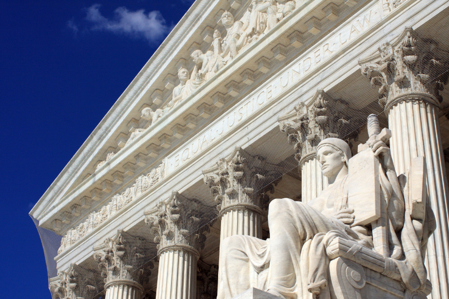 front facade of the supreme court of the united states with some blue sky and clouds behind it