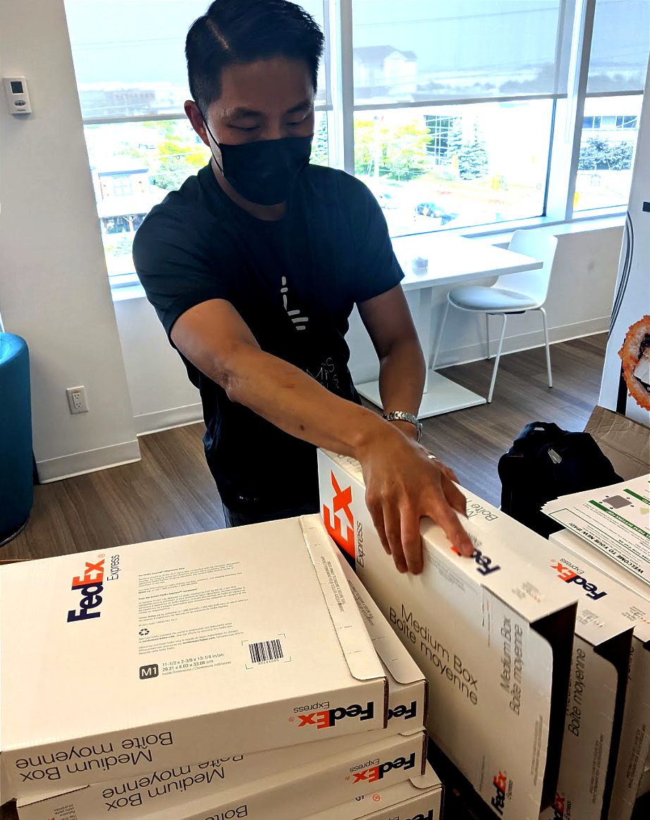 Edwin packing up iPads in shipping boxes at the CDL Mississauga office.