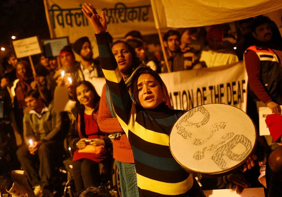 People with disabilities in India protesting. It is a cande light vigil of a group of people.