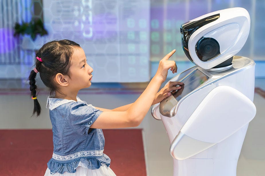 A human child interacting with a robot.