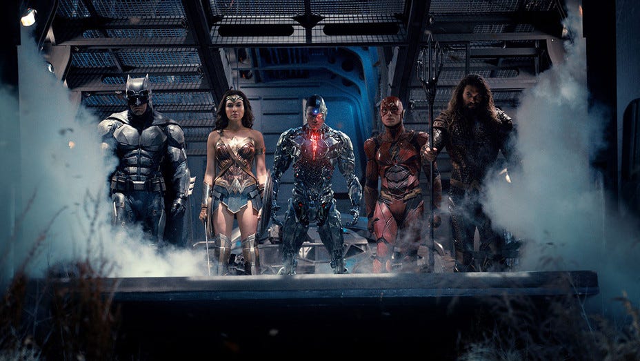 Batman, Wonder Woman, Cyborg, Flash, and Aquaman disembarking a vehicle