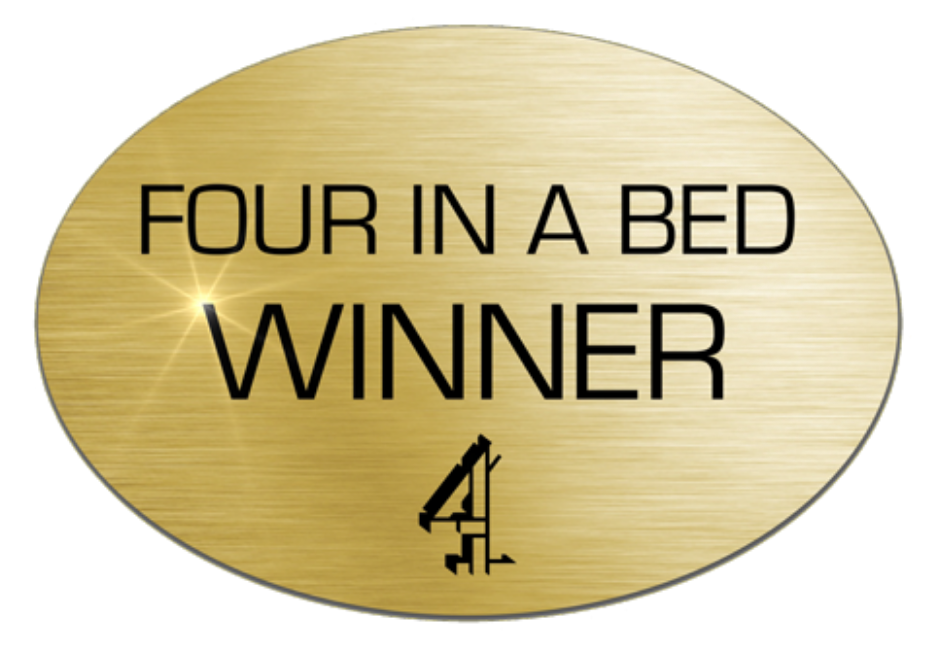 A gold oval plaque, with black writing saying Four in a Bed winner. With the Channel 4 TV logo