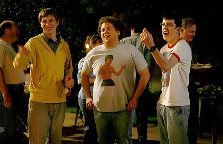 Movie scene from SuperBad Movie, three people are standing with happy emotions