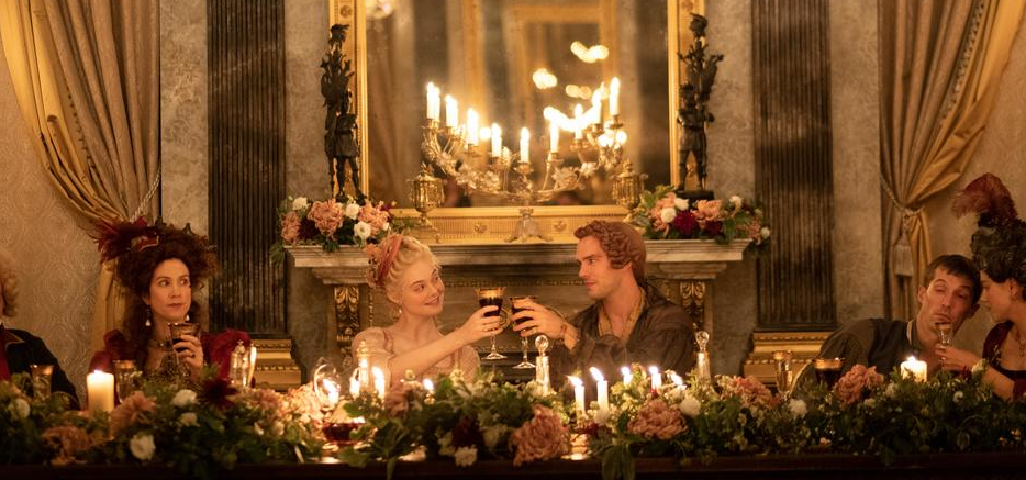 Catherine and Peter toast each other at a lavish banquet while courtiers watch on.