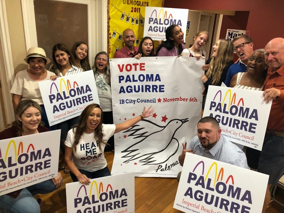 campaign workers with signs for paloma aguirre