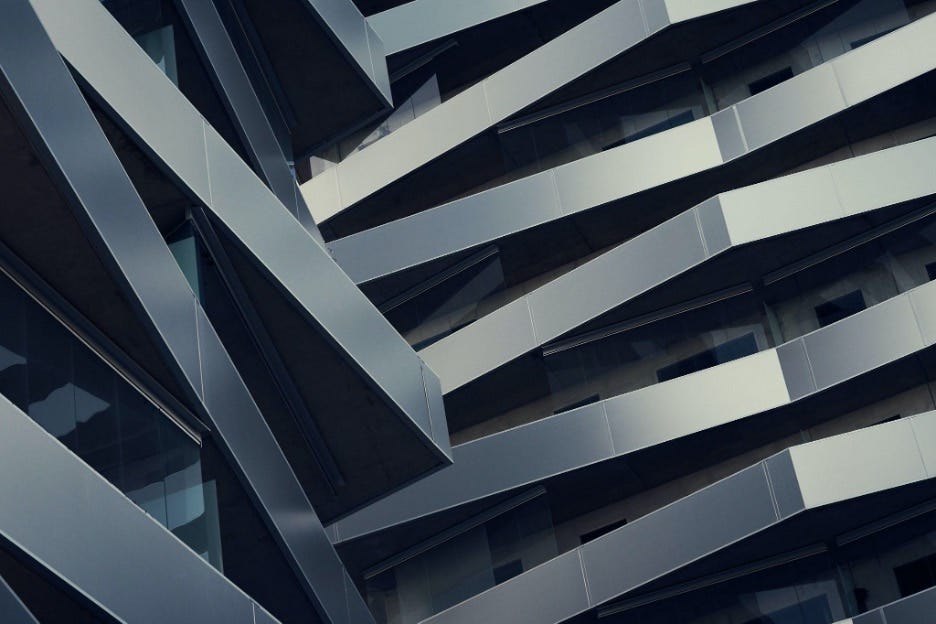 A modernist steel building with geometric balconies shot from below to create an abstract image from the angles.