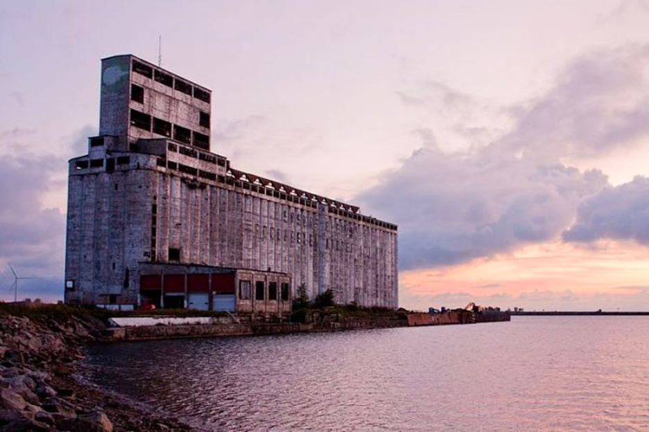 Old grain factory juts out into waterway.