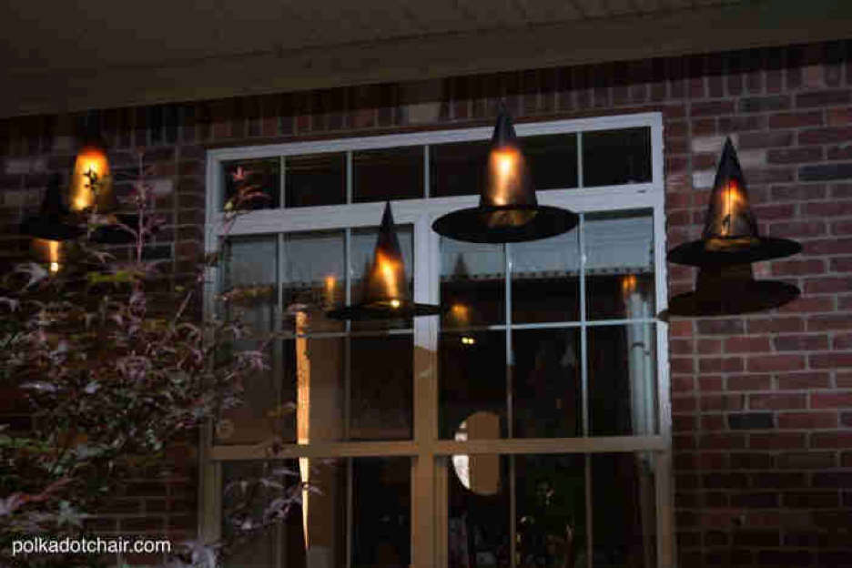 Image of front porch decorated with floating witch hat luminaries.