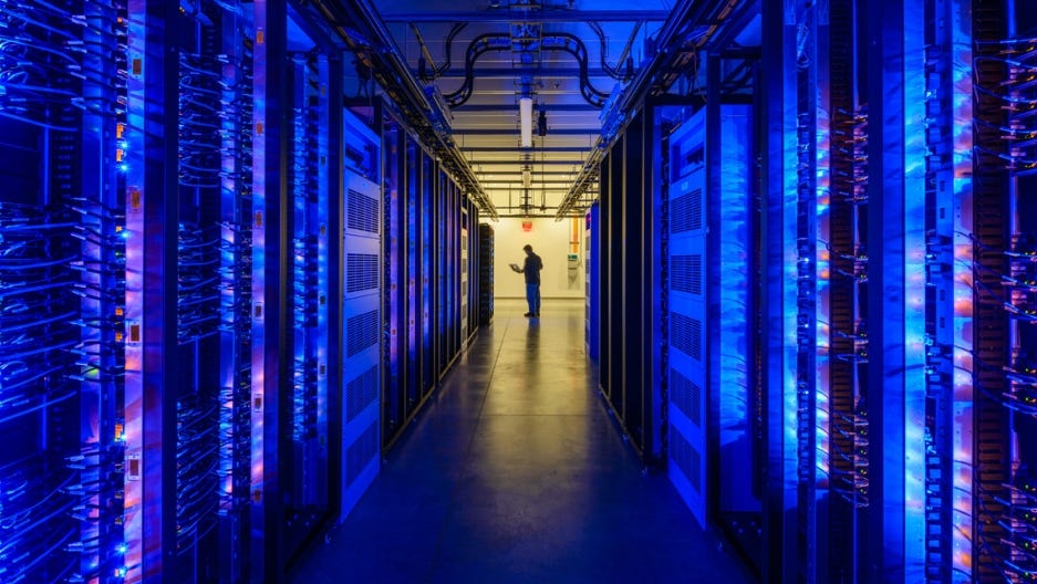 photo of a person at the end of a mysterious data-center corridor