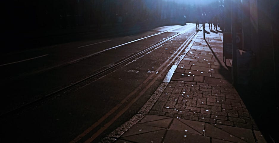 Photo of a dark city street.