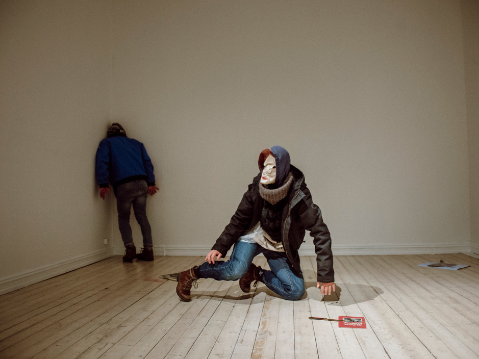 Image of Mia Habib’s dance performance Stranger Within shows two masked dancers in a white room.