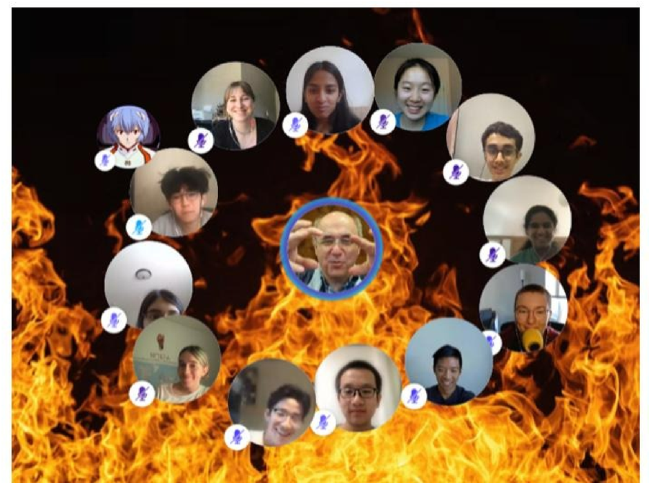 A video conference window, with Stephen Wolfram in the center, surrounded by flames curling up from the darkness. The students’ avatars, both in person and as anime characters, surround his video bubble in a circle as he makes a sign on-screen.