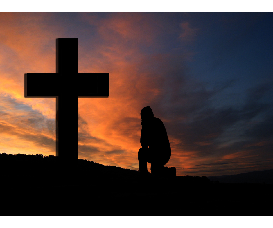 Someone kneeling in front of a Cross