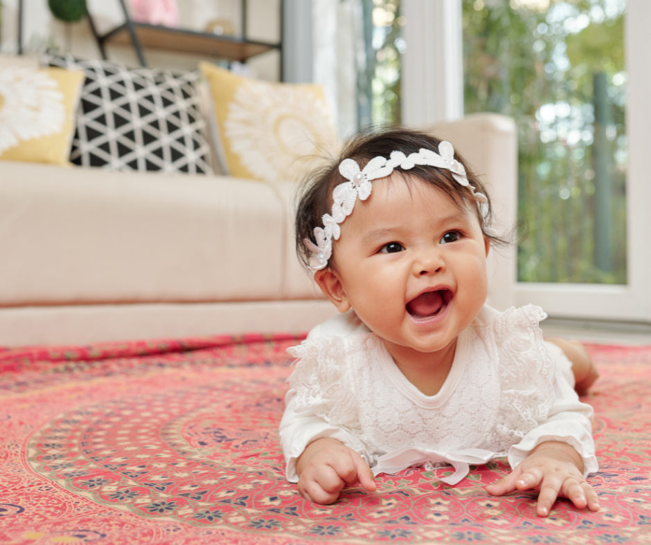 A happy baby crawling on carpet, unaware of the hidden dangers of indoor air pollution. By Dr. Gregory Charlop