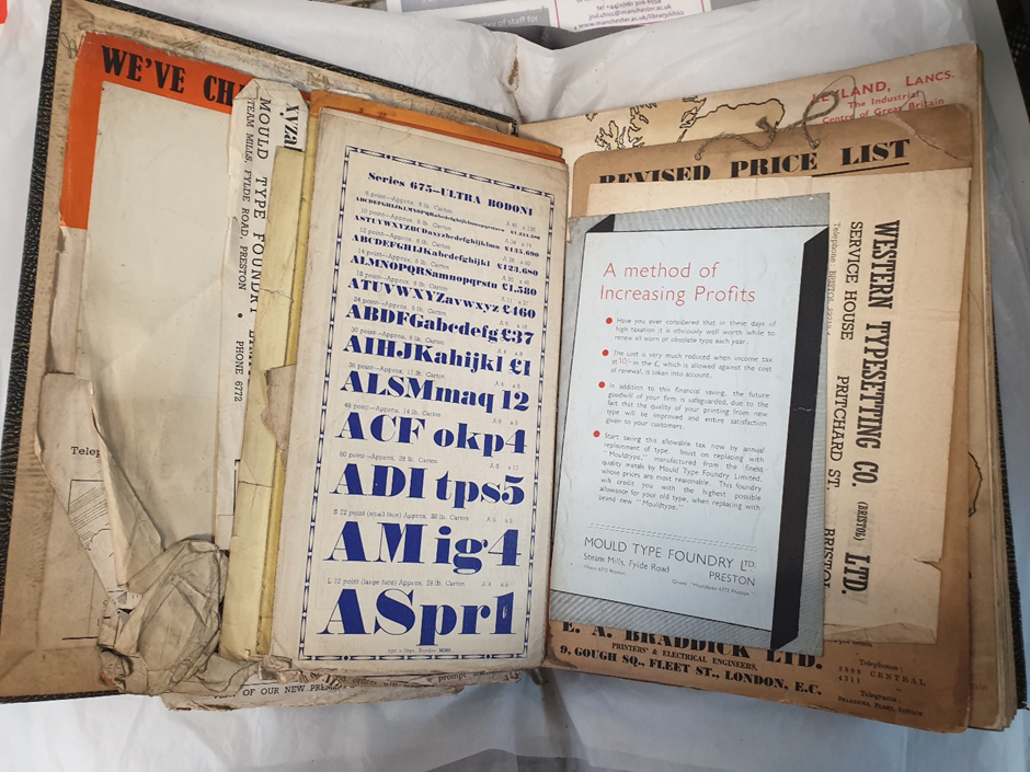 Assorted printed ephemera inserted into the front cover of a book.