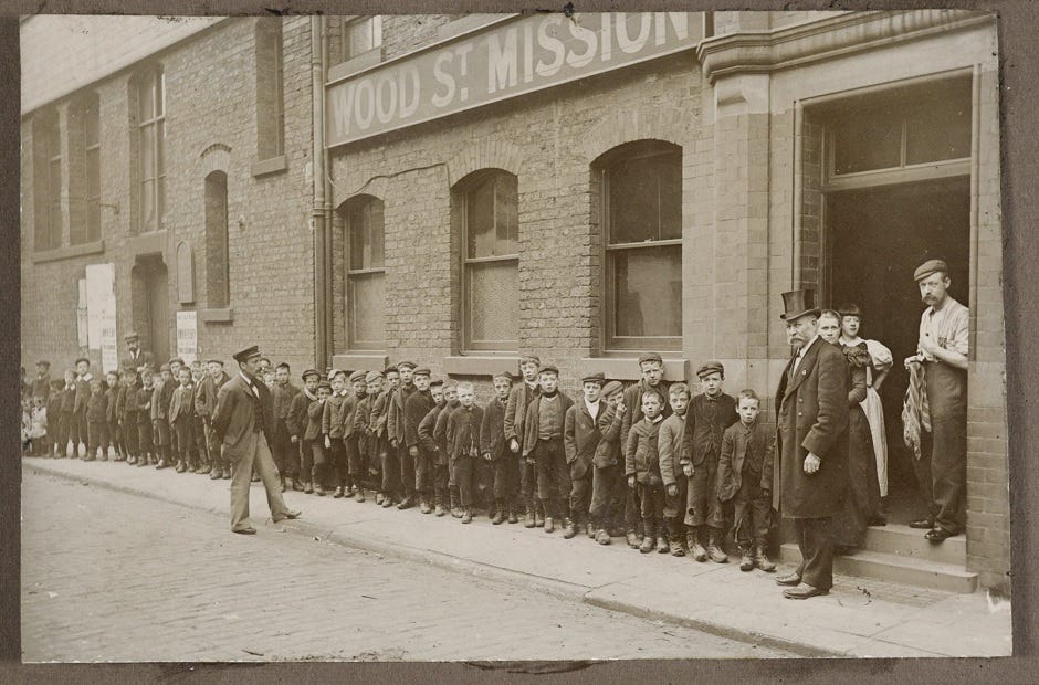 Photograph of a queue of children outside the Mission